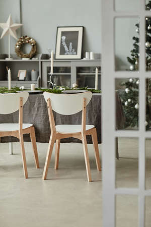Vertical background image of minimal home interior with dining room decorated for Christmas, copy spaceの写真素材