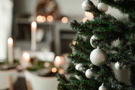 Close up background image of Christmas tree in elegant dining room decorated with grey ad silver tones, copy spaceの写真素材