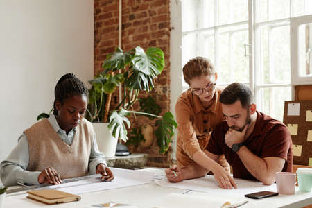 Diverse group of designers and architects working in meeting at officeの写真素材