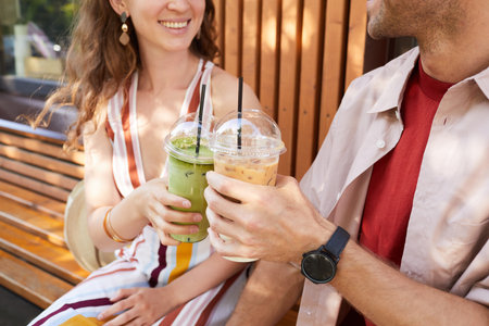 Close up of happy young couple enjoying colorful cocktails in Summer, copy spaceの写真素材
