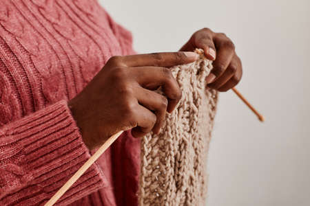Close up of unrecognizable African-American woman knitting scarf, copy spaceの写真素材