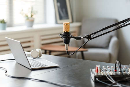 Background image of recording room interior with microphone on stand and laptop setup, copy spaceの写真素材