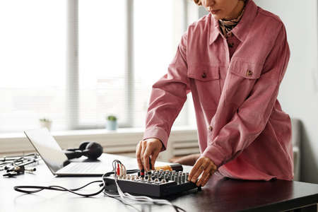 Cropped shot of female creator setting up recording equipment in studio, copy spaceの写真素材