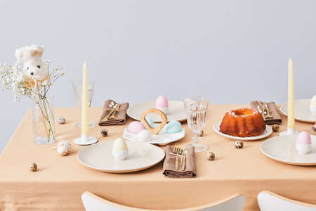 Minimal background image of elegant dinner table decorated for Spring and Easter, copy space