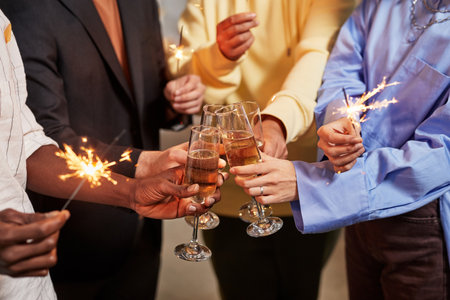 Close up of colleague lighting sparklers while celebrating Birthday in office