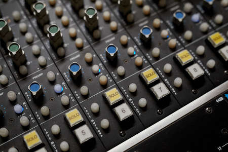 Close up of sound board with buttons and toggles in music recording studio, copy spaceの写真素材