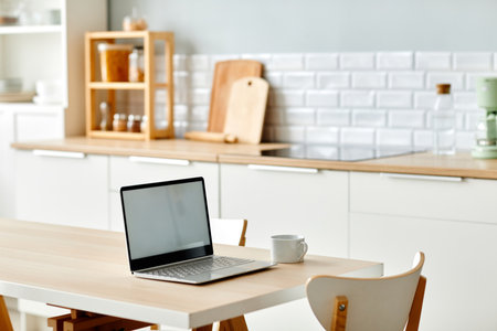 Background image of minimal home office workplace with laptop on kitchen table, copy spaceの写真素材