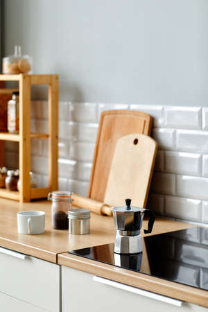 Vertical background image of ozy minimal kitchen with wooden decor elements and coffee pot on stove, copy spaceの写真素材