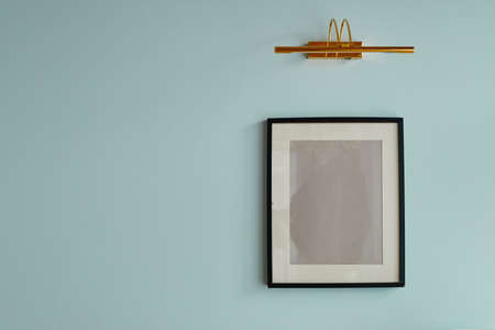 Minimal background image of graphic empty frame on pastel blue wall, picture mock upの写真素材