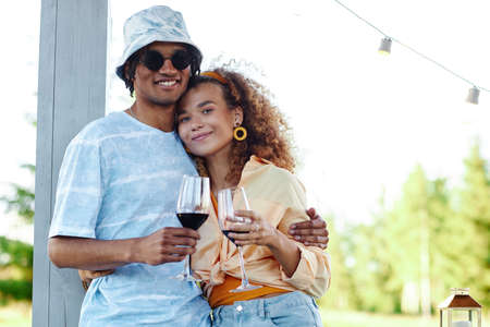 Waist up portrait of young couple embracing outdoors while enjoying romantic date in Summer , copy spaceの写真素材