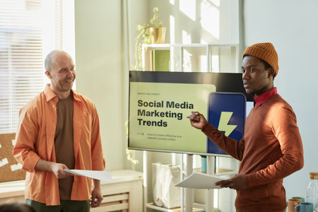Portrait of creative black man presenting Social media marketing trends for business team in office