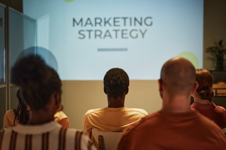 Back view of young black man listening to lecture while sitting in audience in training class, copy spaceの写真素材