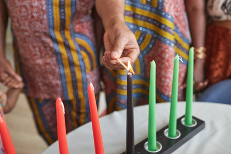 Close-up of family burning candles together for celebration Kwanzaa holidayの写真素材