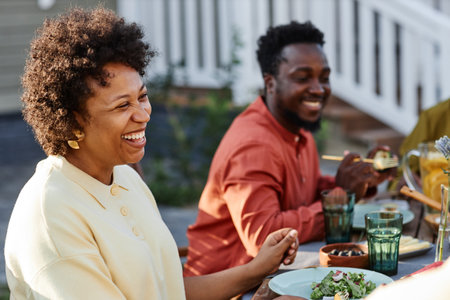 Portrait of happy African American family chatting outdoors during Summer party outdoors and meeting childrenの写真素材