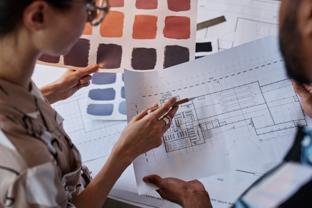 Close up of two architects discussing floor plans and color swatches for interior design projectの写真素材