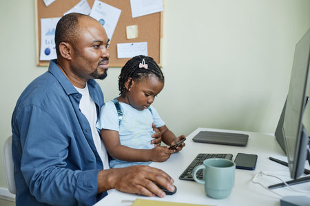 Side view portrait of smiling father with daughter working together in office, take child to work...