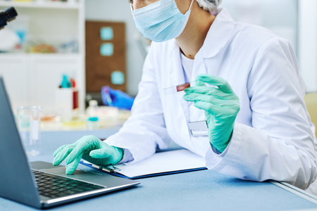 Close up of woman working in modern laboratory and doing blood tests, copy space