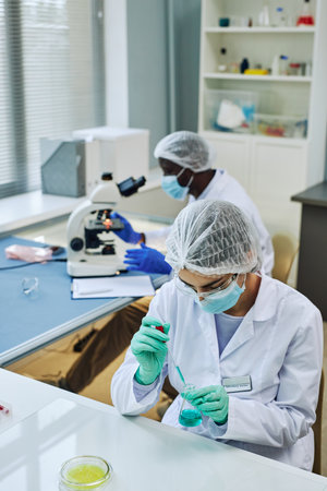 Vertical shot of medical laboratory with two scientists working on researchの写真素材