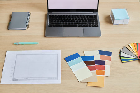 Top view of designers workplace with palette swatches and laptop, copy spaceの写真素材