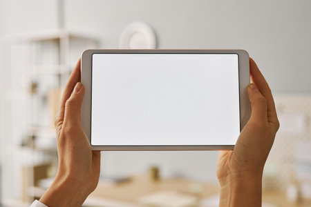 Minimalistic closeup of woman holding digital tablet with white screen mock up