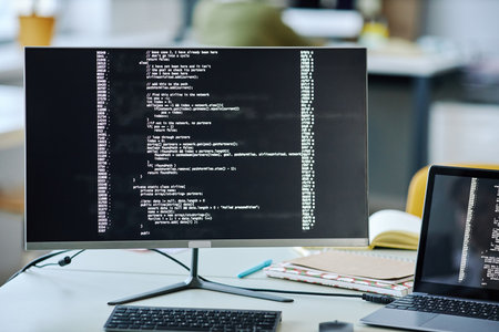 Front view background image of computer screen with code lines on desk in office
