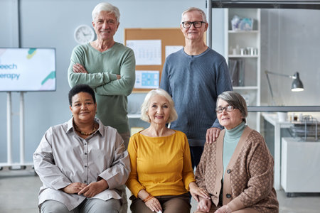 Group portrait of multiethnic seniors posing in medical clinic setting all looking at cameraの写真素材