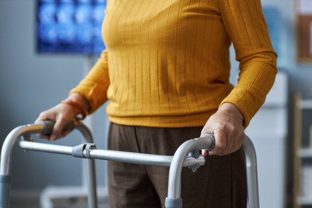 Close up of senior woman using mobility walker in medical clinic setting, copy spaceの写真素材
