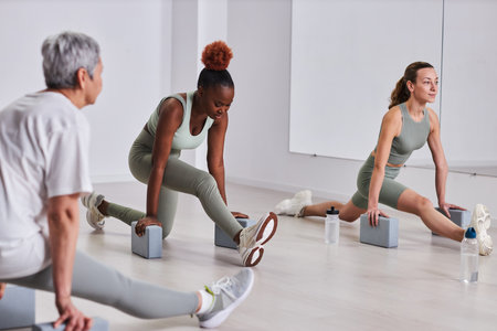 Group of people doing exercises during aerobics in health clubの写真素材
