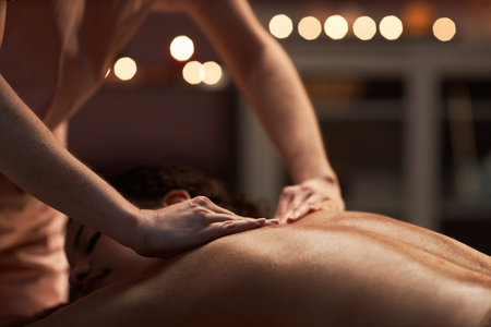 Closeup image of woman getting back massage with oils in beauty salonの写真素材