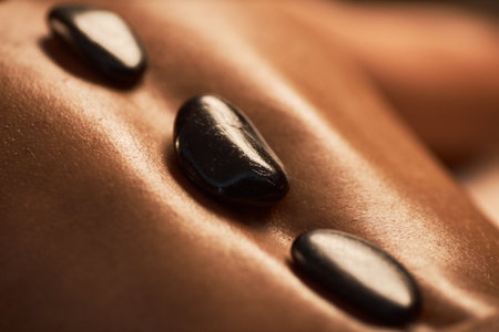 Warm basalt stones on back of young womanの写真素材