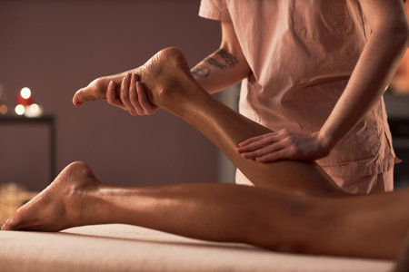 Woman getting relaxing leg massage in spa salonの写真素材