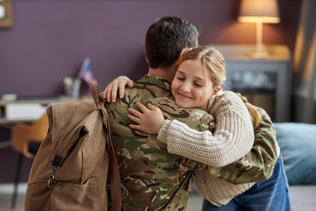 Portrait of smiling girl hugging father coming back home from militaryの写真素材