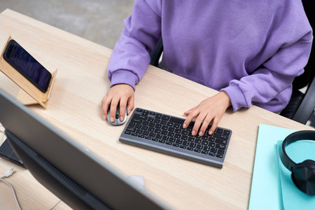 Top view at female IT professional working at home and typing, copy space