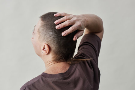 Side view at mature bald woman struggling with alopecia against white background, copy spaceの写真素材