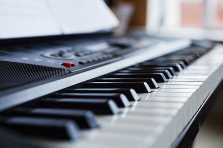 Close-up of synthesizer with sheet music for playing music in classの写真素材