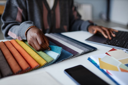 Close-up of designer working with colored palette at his workplace, he choosing colour for interiorの写真素材