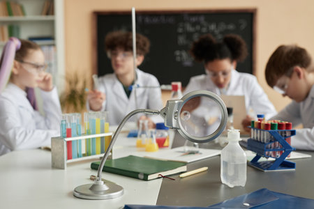 Close up of laboratory equipment in science class with group of children in background