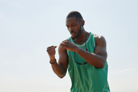 African American man doing physical exercises during sport training outdoorsの写真素材