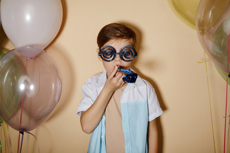 Minimal waist up portrait of party boy with balloons in pastel colors shot with flash.