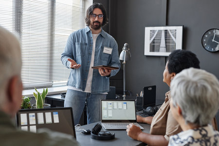 Portrait of smiling man working as teacher in IT programming class for senior people, copy space