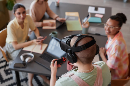 Top view at young woman using VR headset in modern IT team meeting, copy spaceの写真素材