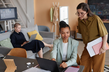 Pastel high angle portrait of successful all female business team working together in modern officeの写真素材