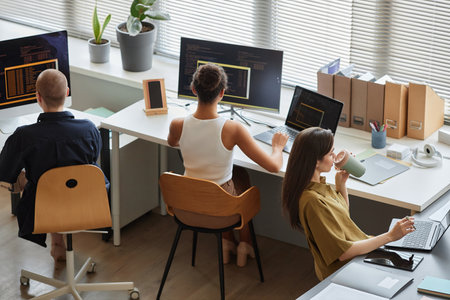 Back view at all female business team working on IT project in office, copy spaceの写真素材