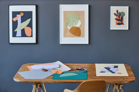 Workplace of creative designer of interior, artist or other craftsperson with papers of various colors, scissors, sharp knives and other suppliesの写真素材