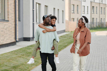 Happy African American family enjoying their walk outdoors in the city