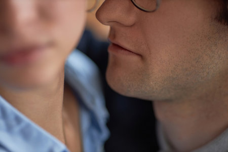 Closeup up of man intimidating woman in office dangerously close to her face, workplace harassment sceneの写真素材