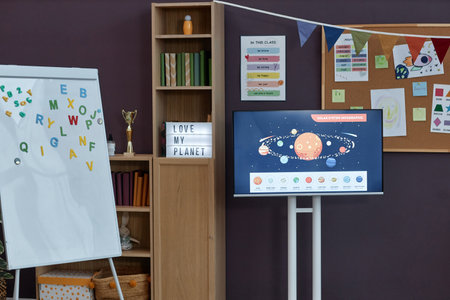 Background image of learning materials in preschool room interior with whiteboard and space theme...