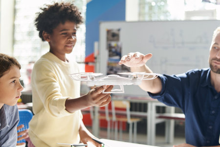 Physics teacher explaining kid how propellers of quadcopter worksの写真素材