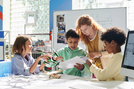 Schoolchildren reading manual when assembling quadcopterの写真素材