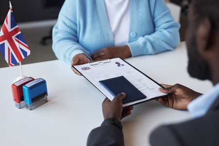 Young African American female manager of visa application center passing documents to male applicant over desk after approvingの写真素材